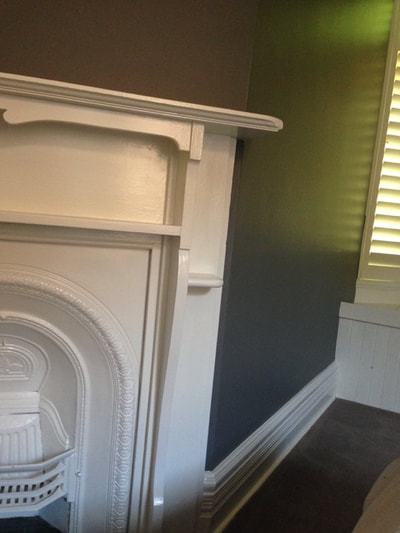 Very dark wall colours can be softened with 'outlining' white trim.