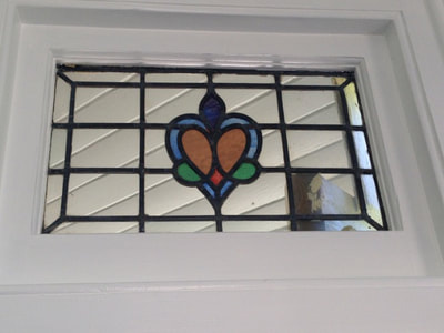 The best way to make stained glass pop? White painted window frames.