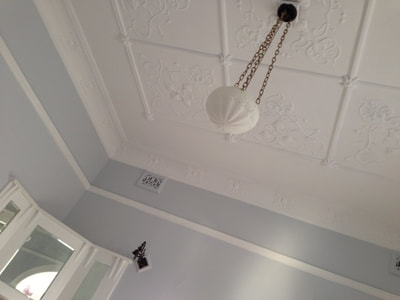 Painting historic moulded ceilings in flat white hides minor damage. 