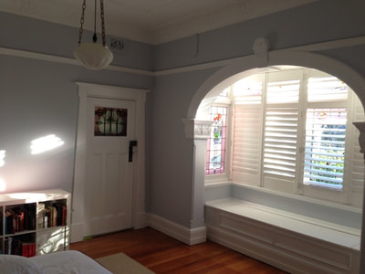 Grey walls, white trim and ceiling, and warm timber floors.
